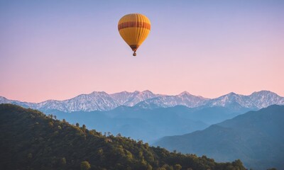 Hot air balloon flying over snow-capped mountains at sunrise
