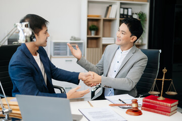 Asian business team and lawyers discussing contract papers sitting at the table. Concepts of law, advice, legal services.