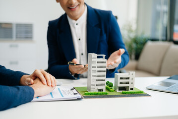 balancing the property sector The real estate agent is explaining the house style to see the house...