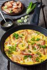 deli ham onion omelette on skillet, top view