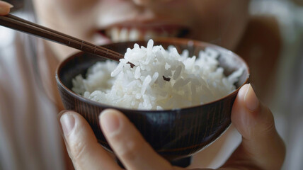 person eating rice in a bowl