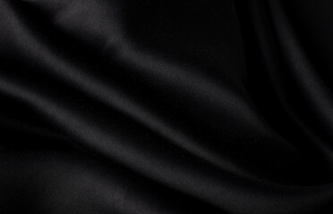 Obraz premium Black silk waves fabric texture, Luxury fabric textile for fashion cloth,