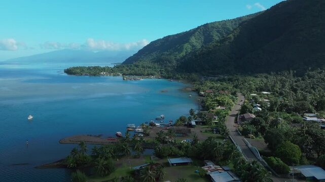 Teahupoo Tahiti French Polynesia aerial drone view road streets up island coast to Papeete morning sunny sunshine bay channel coral reef mountainside car traffic jeep roadtrip drive forward pan up