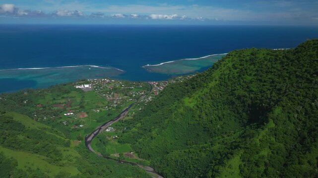 Teahupoo town Tahiti French Polynesia aerial drone Papeete mountainside coast morning sunny bluesky bay reef Paris Olympics 2024 surf surfer surfer venue new judge tower pedestrian bridge down forward
