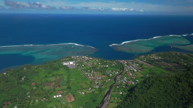 Teahupoo town Tahiti French Polynesia aerial drone mountainside coast morning sunny bluesky bay reef Papeete Paris Olympics 2024 surf surfer surfer venue new judge tower pedestrian bridge forward pan