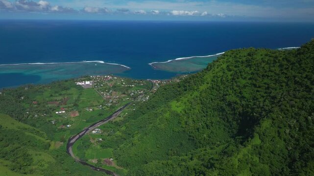 Teahupoo town Tahiti French Polynesia aerial drone mountainside coast morning sunny bluesky bay reef Papeete Paris Olympics 2024 surf surfer surfer venue new judge tower pedestrian bridge forward down