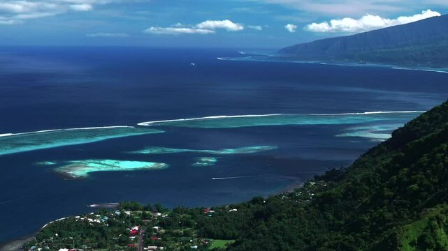 Coral reef break of Teahupoo wave Tahiti French Polynesia aerial drone parallax coast morning sunny bluesky channel bay Papeete Paris Olympics 2024 surf surfer surfer venue circle left parallax motion