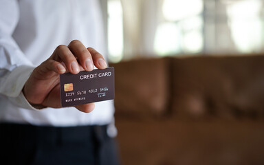 Side view closeup of young man paying with credit card in tech store, copy space
