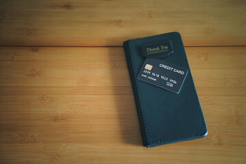 The black credit card on leather black bill receipt. 