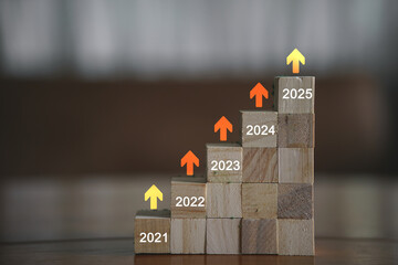 Starting new year 2025. Flipping of 2024 to 2025 on wooden cube blocks. Beginning and start of the...
