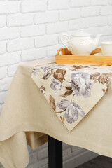 White Brick Wall With Beige Tablecloth and Basket
