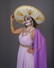 Studio portrait of woman made up with sugar skull, catrina. Day of the dead and halloween...