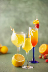 Set of limoncello cocktails in glasses on a green background. Limoncello spritz and margarita. Summer drinks