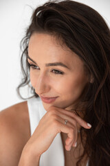 Fototapeta premium Happy beautiful girl posing in a new hot summer look. Wearing blue jeans and white waistcoat