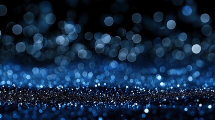 Enchanting Abstract Background with Blue Bokeh Lights and Glitter on Dark Black Night for Holiday Celebration Design