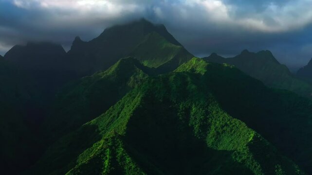 Sunset light towering mountain peaks valley town village Teahupoo Tahiti French Polynesia aerial drone view incredible dark clouds island landscape Moorea Bora Bora Papeete circle right slowly