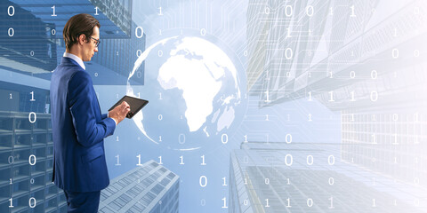 Attractive young european businessman using tablet with light digital globe on bright tech city background with mock up place. Double exposure.