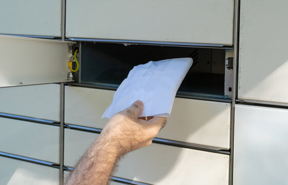 InPost parcel locker branding, modern delivery system, organized compartments, outdoor setting, editorial image