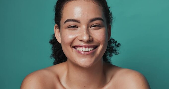 Face, skincare and woman with cosmetics, dermatology and pimple treatment on green studio background. Portrait, person or model with acne care results, glow and tea tree oil with routine or vitamin A