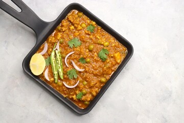 Indian famous dish Mutton matar Kheema Pav or Khima Paav is a minced goat meat curry. Mutton keema is cooked with onion, tomatoes, potatoes, and green peas along with Indian spices. copy sapce.