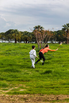 Mother with son playing badminton in the park
