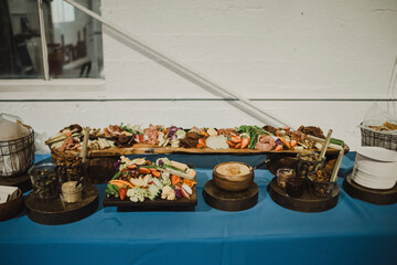 Colorful charcuterie spread with assorted vegetables, meats, and dips.
