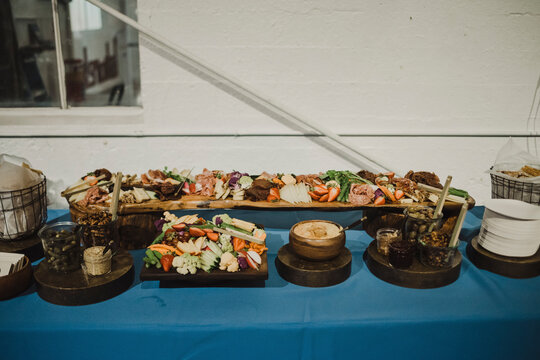 Colorful charcuterie spread with assorted vegetables, meats, and dips.
