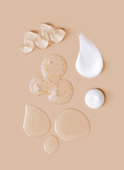 creamy texture of cosmetic samples on a pastel beige background