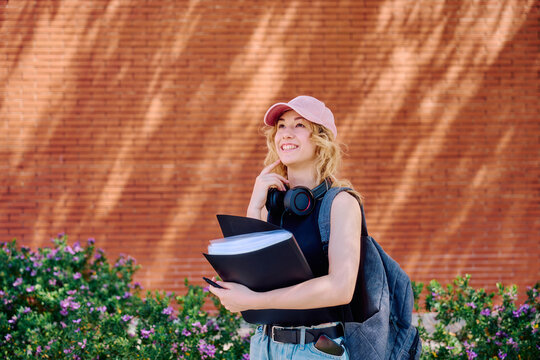 University student with books and headphones