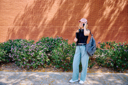 Student talking on phone outside building