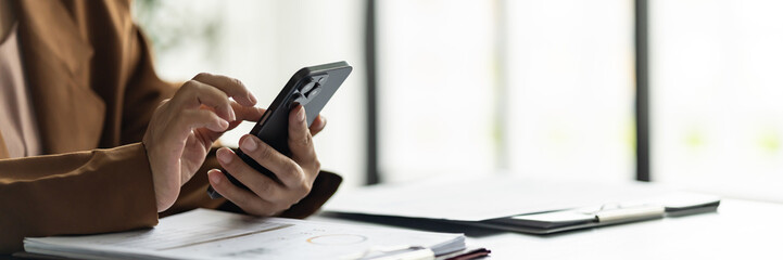 Close up hands using cellphone searching on internet