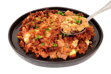 Traditional corned beef hash meal isolated on a white background