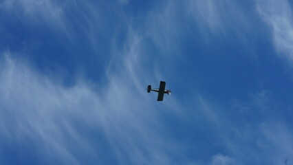 One plane flying over in the blue sky in autumn