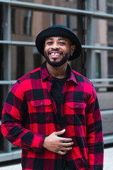 Man portrait. Style. Handsome Afro American guy in red jacket is looking at camera and smiling