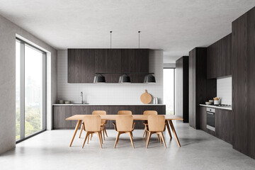 Home kitchen interior with cooking cabinet, dining table and panoramic window