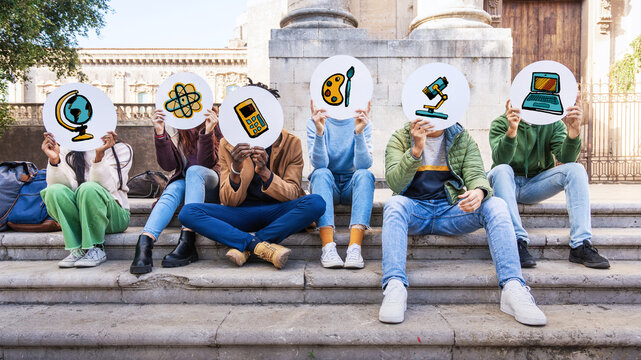 Students holding education icons on campus: diversity in STEM subject