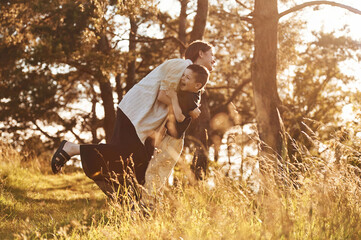 Having fun. Mother and son are in the forest together