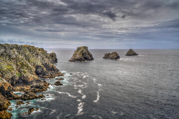 Rocks , stones and sunset on the beach and exotic blue and pink sky