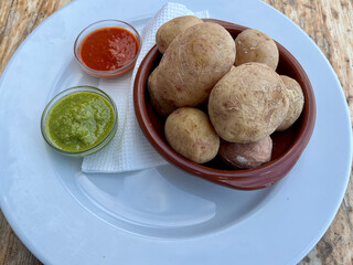 Canary Islands dish Papas Arrugadas wrinkly salty potatoes with and Mojo picon red spicy sauce.