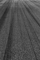 Asphalt race track with black tire mark texture and background, Abstract asphalt road race track background , Tire mark on race track texture and background. © Kalyakan