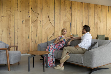 Handsome couple drinking coffee in the hotel lobby