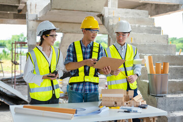 Group architect team on construction site inspection documents and business workflow in the morning.