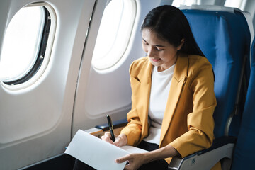 Airplane, travel and portrait of businessman working on laptop computer and smartphone while sitting in airplane.