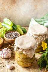 Healthy homemade fermented food. Salted pickled cucumbers salad preserved canned in glass jar. Home economics, autumn harvest preservation. Copy space.
