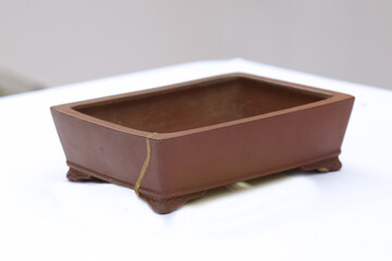Brown empty bonsai pot on white background
