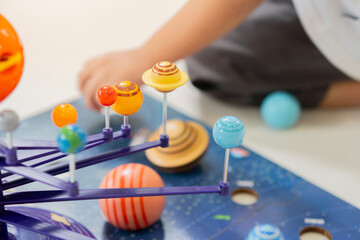 Little boy having fun time with Solar system toys at home for learning Solar system planets. © Kunlathida