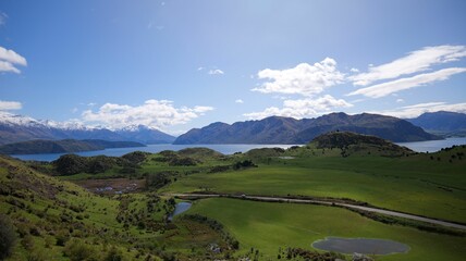 Stunning landscape view of Lake Wanaka with surrounding mountains under a clear blue sky
