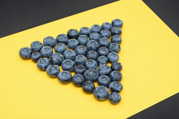 Fresh blueberry on yellow background