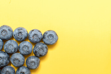Fresh blueberry on yellow background