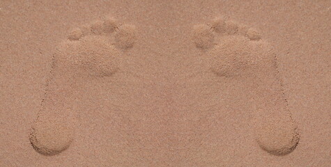 Top view of footprints in sand at beach, lonely trace on sandy surface on coast. Summer sea vacation and leisure at sea concept